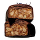 Two stacked chocolate-covered bars with a cut cross-section showing a caramel and almond filling, photographed on a black background.