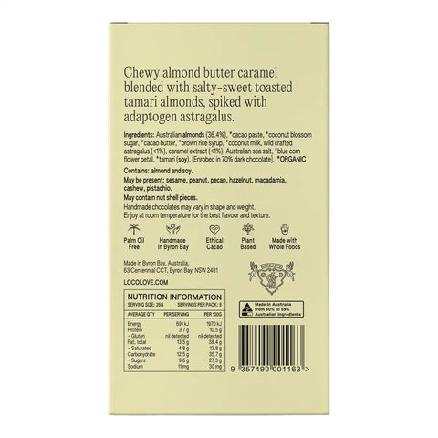 The back of a chocolate bar package in a pale beige color, featuring product details, ingredients, icons, and a barcode.