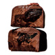 Two halves of a chocolate confection stacked vertically, showing a rich dark chocolate center.