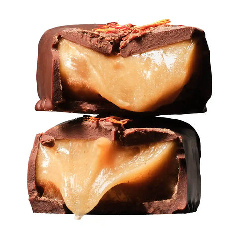 Classic chewy caramel chocolate cut in half and stacked with gooey caramel.