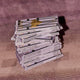 Large stack of hazelnut chocolate bars on a purple fabric.
