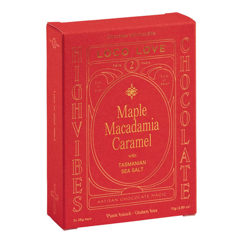 Red packaging of Maple Macadamia Caramel chocolate with gold text on a white background.