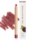 A deep maroon lipstick crayon, placed on a swatch of its color and texture, next to its packaging.
