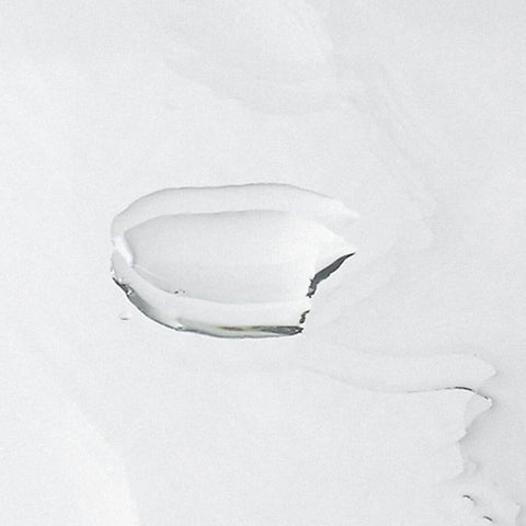 Clear liquid on a reflective surface.