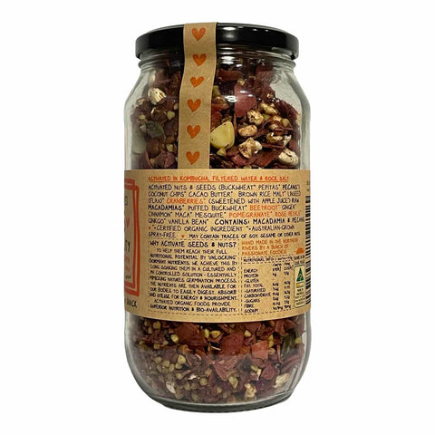 A glass jar of Mindful Foods Kombucha with a black lid and a tan paper label featuring orange text and heart graphics, set against a plain white background.
