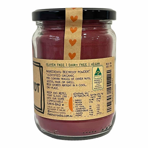 A refillable glass jar of beetroot powder with a black lid and a kraft paper label, shown on a plain white background.
