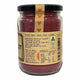 A refillable glass jar of beetroot powder with a black lid and a kraft paper label, shown on a plain white background.