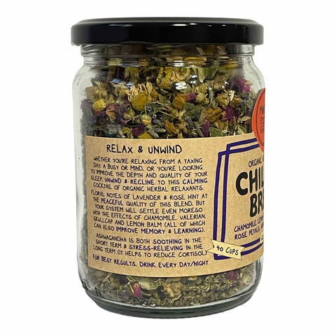 A glass jar of Chumbaloo 'Relax & Unwind' herbal tea blend with a black lid and a beige label, shown on a white background.