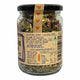 A glass jar of Mindful Foods 'It's Time to Chillax' herbal tea blend, featuring a black lid, a kraft paper label with text and a small orange heart graphic, and dried herbs visible inside.