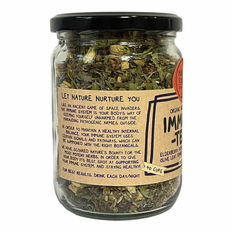 A glass jar of Imm-Tek Elderberry Green Tea Leaves with a black lid and a kraft paper label, shown on a white background.