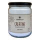 A glass jar of Stardust Creatine Monohydrate with a black lid and a beige label, shown against a plain white background.