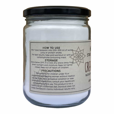 A clear glass jar of pure creatine monohydrate with a black lid and a label with usage & storage instructions and precautions. 