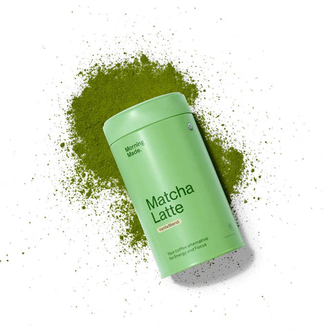Green container labeled 'Matcha Latte' with matcha powder on a white background
