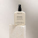 MUKTI Botanique Deodorant - Citrus & Siberian Fir 100ml spray bottle on a stone block.