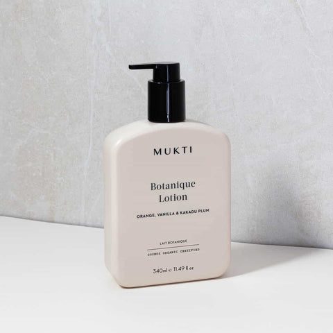 Mukti Botanique Lotion bottle on a light gray background