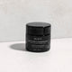 Gentle Melt Cleansing Balm on a textured surface.