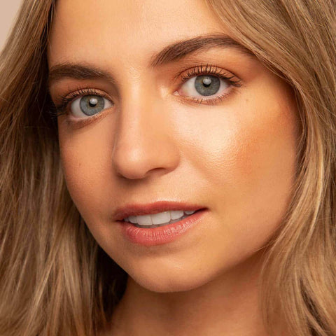 Close-up of a person with blonde hair and blue eyes.