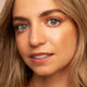 Close-up of a person with blonde hair and blue eyes.