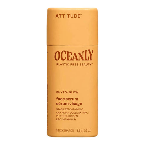 Orange face serum stick with 'Attitude' branding on a white background.