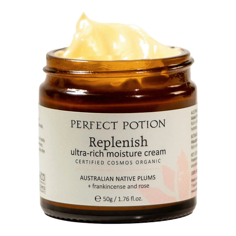 A 50g jar of Perfect Potion Replenish ultra-rich moisture cream, showing the pale yellow cream swirled at the top of the open amber glass jar against a white background.