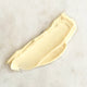 Swatch of thick creamy replenish moisturiser on a marble surface.