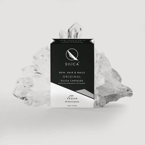 Qsilica capsules packaging with crystals on a light grey background.