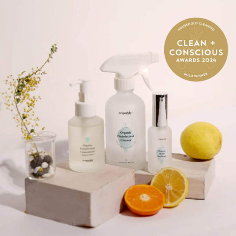 Three bottles of resparkle organic disinfectant cleaning products with a lemon and orange on a white background, featuring the 'Clean + Conscious Awards 2024' gold winner badge.