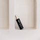 Black Retreatment Botanics Collagen Calm Activated Mist 100ml with gold cap on a white textured background.