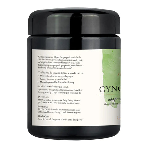 A black herbal tea jar with a black lid and a white label featuring green accents and text.