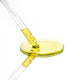 Close-up of a dropper with yellow liquid on a white background