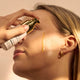 Person applying a The Jojoba Company Pigmentation Oil product to their face.