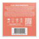 Back of a solid shampoo product box with a coral-pink background, white text listing plant-based ingredients, icons for made in Australia, FSC, soy-based, and compostable, and a barcode.