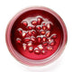 Pomegranate seeds in a clear glass bowl on a white background.
