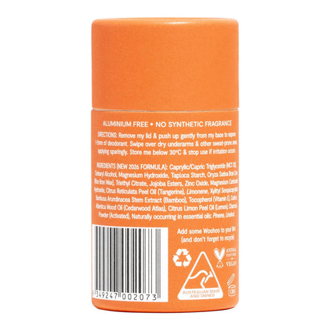 An orange cylindrical bottle of stick of deodorant from Woohoo shown from the back, featuring a white text label with a barcode, ingredients list, and recycling symbols on a white background.