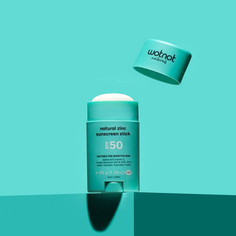 Wotnot natural zinc sunscreen stick on a teal background